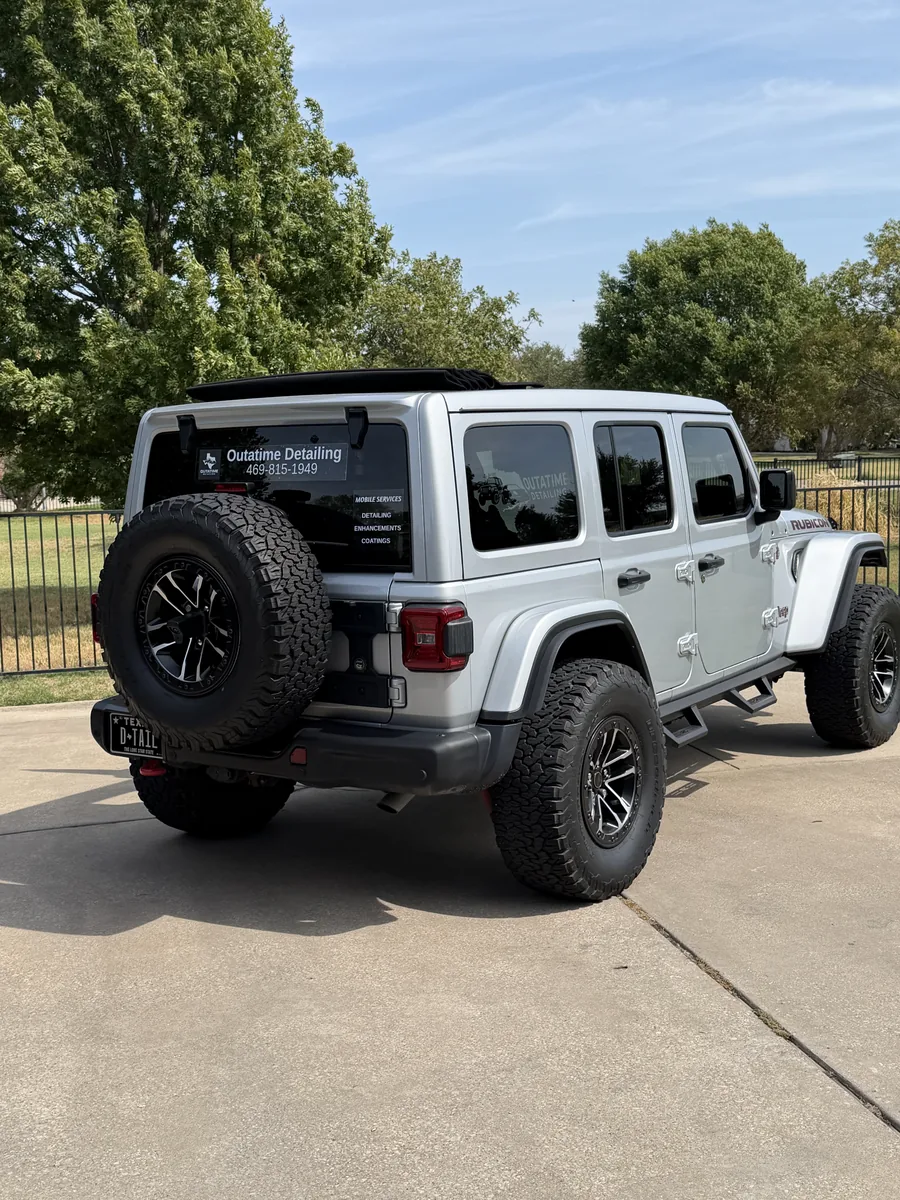 The OutaTime Detailing Jeep, rear three-quarter view on a driveway