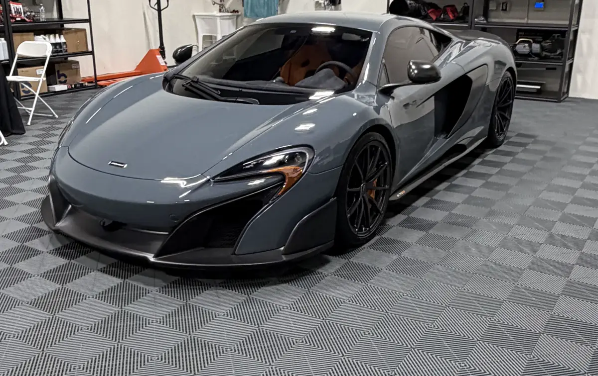 Gray McLaren in a garage